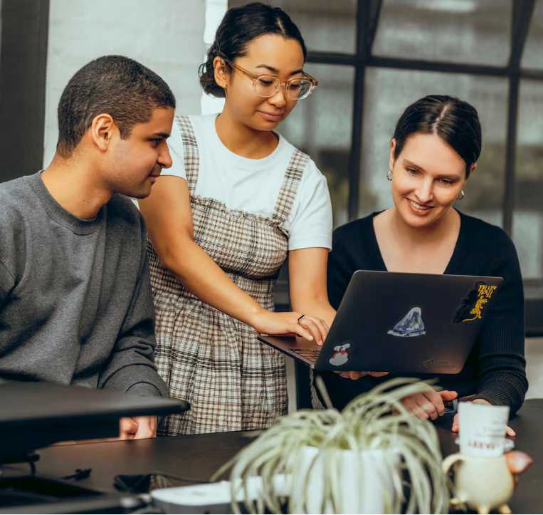 Young consultants collaborating in front of laptop