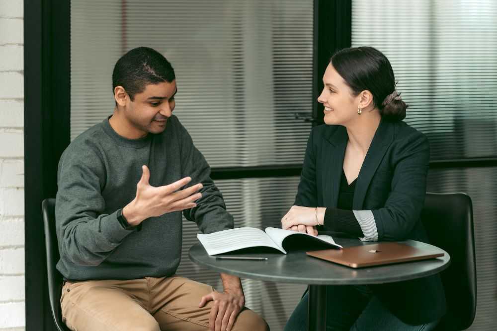 Image of two colleagues discussing digital capability